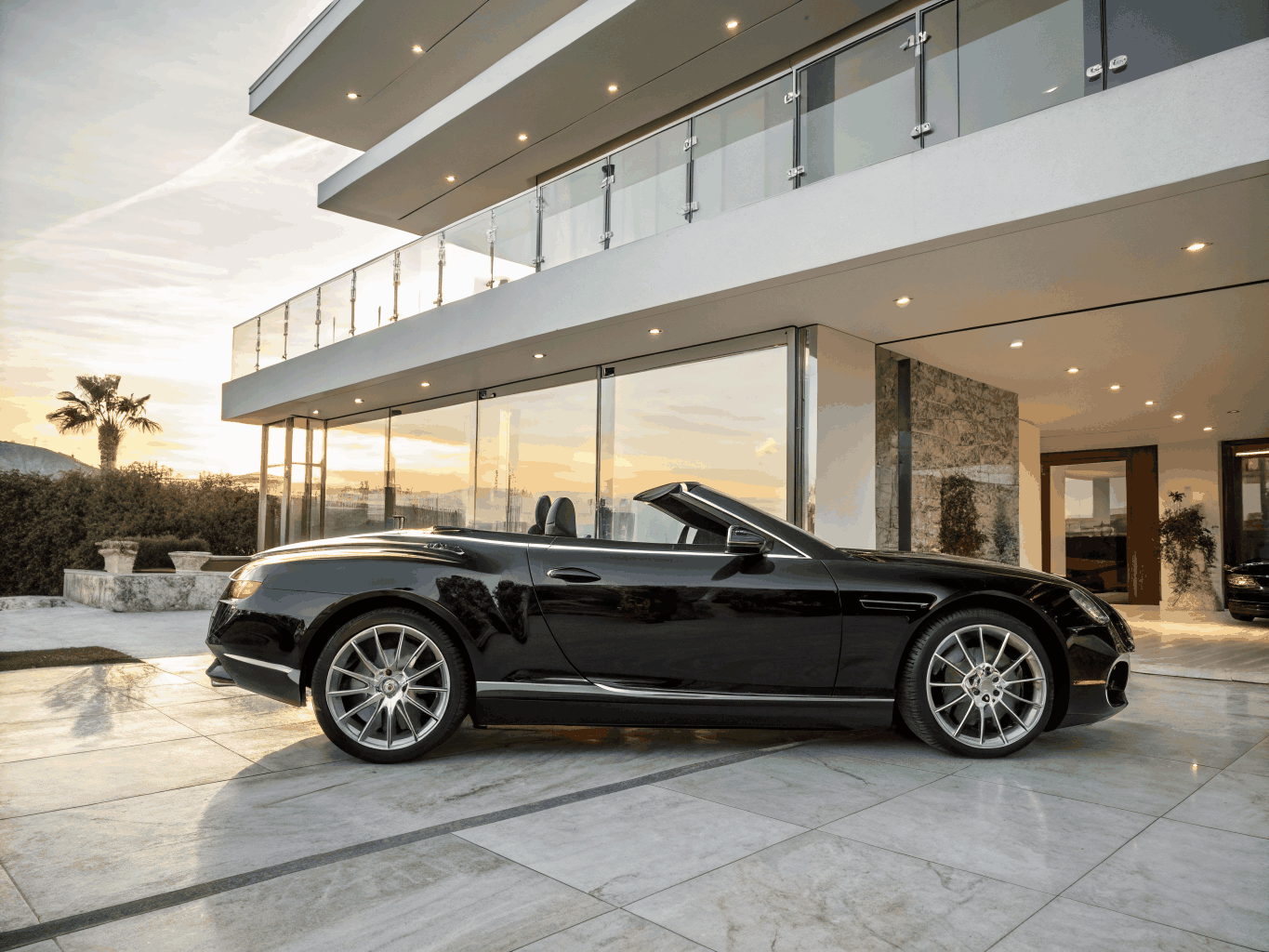Polished sports car staged for sale photography on clean driveway
